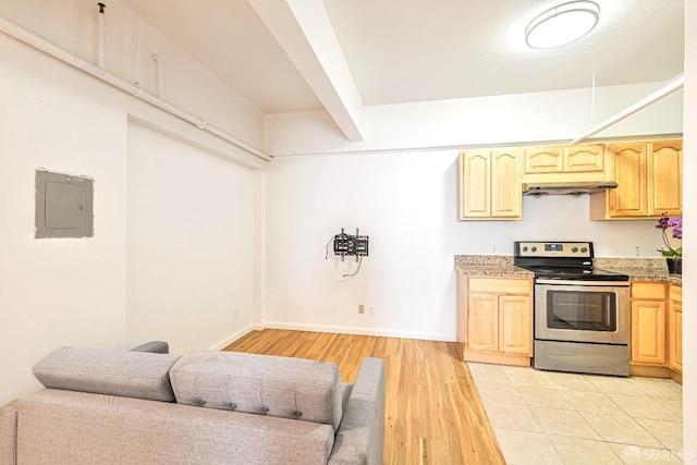kitchen with stainless steel range with electric cooktop, electric panel, light brown cabinets, light wood-style floors, and light stone counters