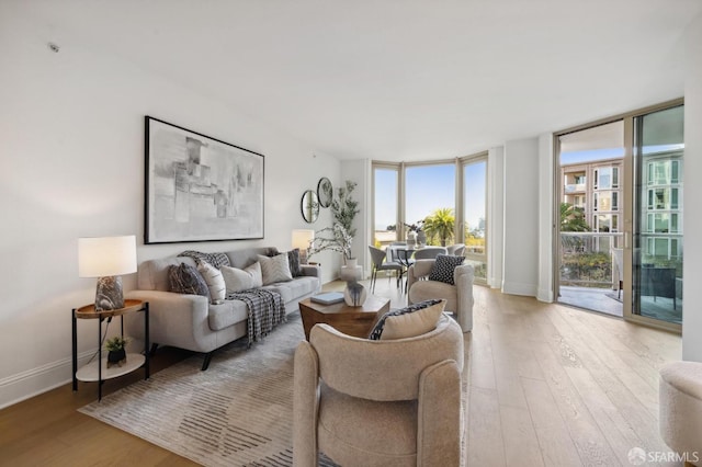 living room with light wood-type flooring and expansive windows