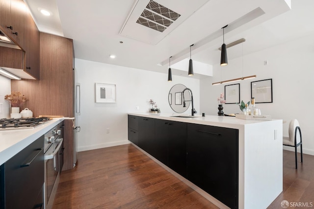 kitchen with dark wood-style floors, modern cabinets, light countertops, and a sink