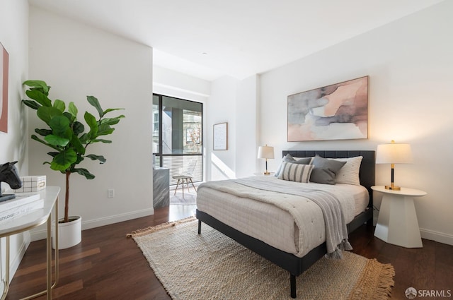 bedroom featuring dark wood-type flooring and baseboards