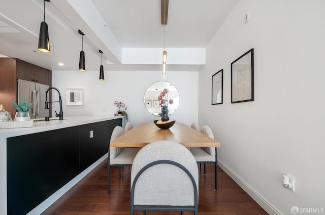 dining room with dark wood-type flooring and baseboards