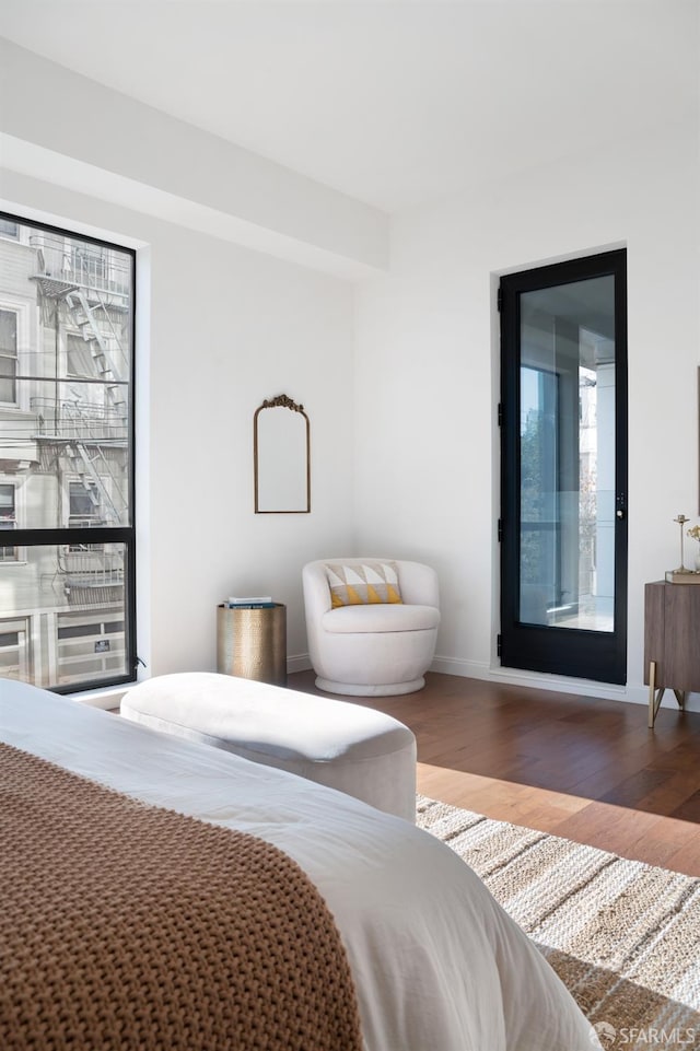 bedroom featuring baseboards and wood finished floors