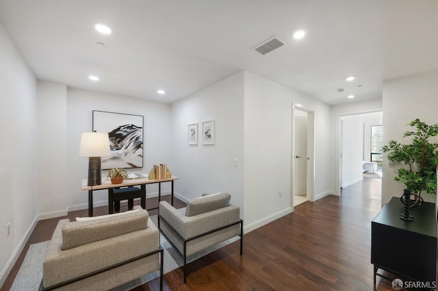 interior space with dark wood-style floors, recessed lighting, visible vents, and baseboards