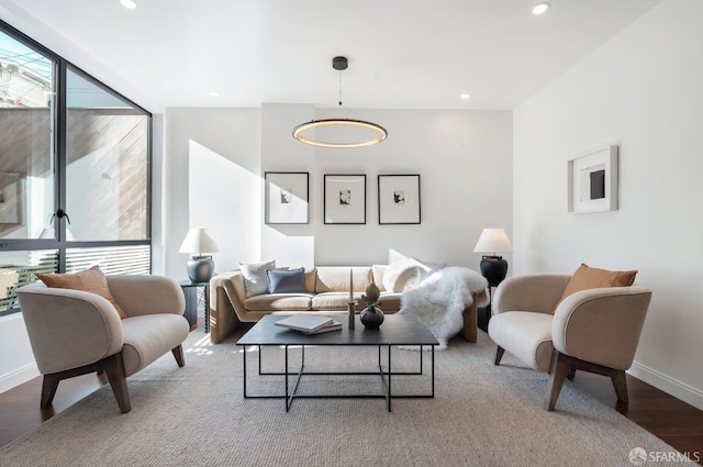 living room with baseboards, wood finished floors, and recessed lighting