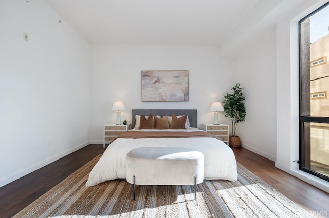 bedroom featuring baseboards and wood finished floors