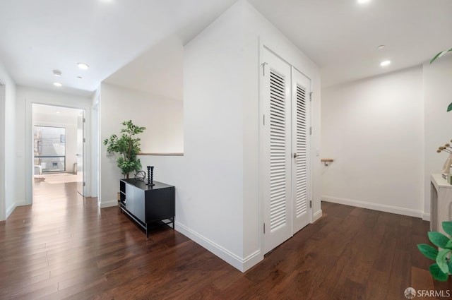 corridor featuring recessed lighting, wood finished floors, and baseboards