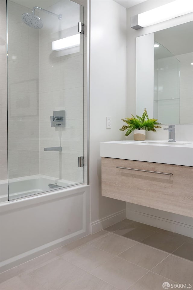 full bath with shower / bath combination with glass door, vanity, and tile patterned floors