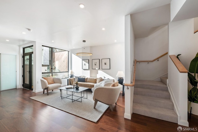 living area featuring stairs, baseboards, wood finished floors, and recessed lighting