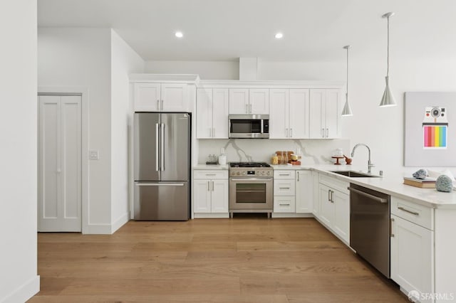 2237 Bryant St Lower, Lower, San Francisco, CA 94110 - kitchen with appliances with stainless steel finishes, a sink, white cabinets, light countertops, and light wood-style flooring
