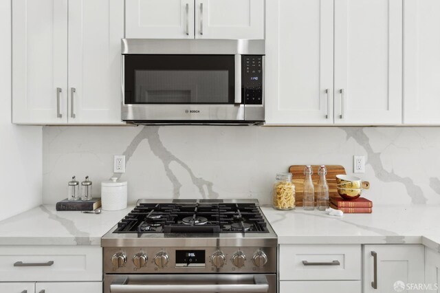 2237 Bryant St Lower, Lower, San Francisco, CA 94110 - kitchen featuring stainless steel appliances, backsplash, white cabinets, and light stone counters