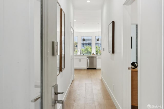 2237 Bryant St Lower, Lower, San Francisco, CA 94110 - hallway with light wood-type flooring, recessed lighting, a sink, and baseboards