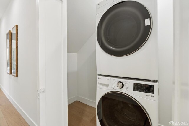 2237 Bryant St Lower, Lower, San Francisco, CA 94110 - laundry room with stacked washer / drying machine, light wood-style floors, and baseboards