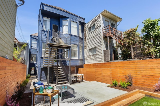2237 Bryant St Lower, Lower, San Francisco, CA 94110 - rear view of property with stairs, a fenced backyard, and a patio area