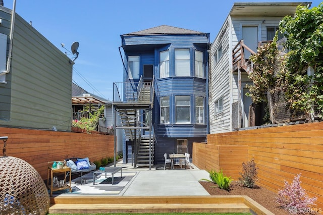 2237 Bryant St Lower, Lower, San Francisco, CA 94110 - back of house with stairs, an outdoor living space, and a patio area