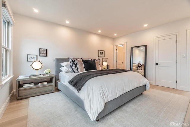 bedroom featuring light wood-style floors, recessed lighting, and baseboards