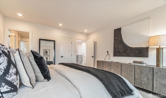 bedroom featuring ensuite bathroom and recessed lighting