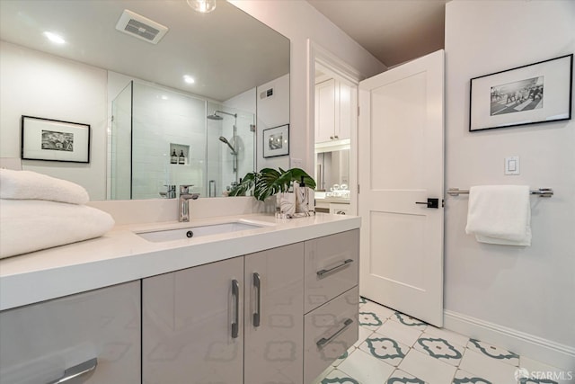 bathroom with recessed lighting, vanity, baseboards, visible vents, and a stall shower