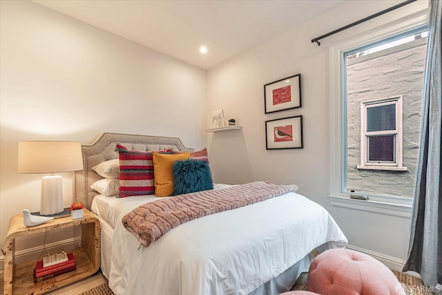 bedroom featuring multiple windows and recessed lighting