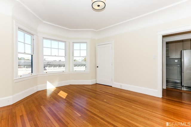 empty room featuring baseboards and wood finished floors