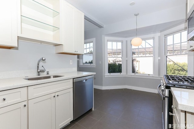 kitchen featuring white cabinets, open shelves, appliances with stainless steel finishes, and a sink