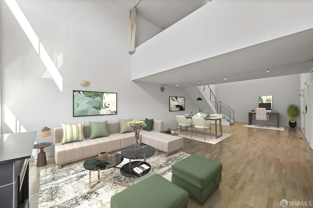 living room featuring stairs, a high ceiling, and wood finished floors