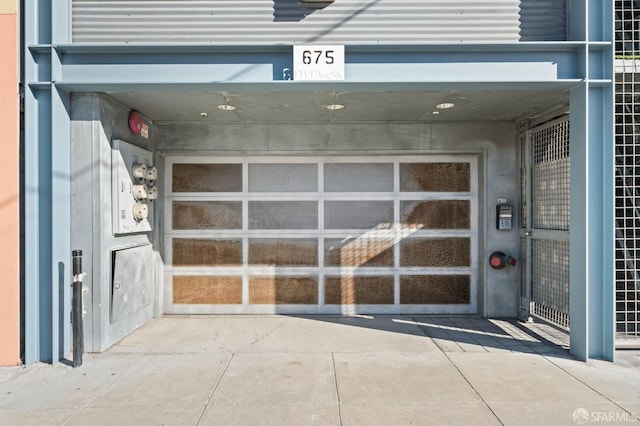 doorway to property featuring a garage and concrete driveway