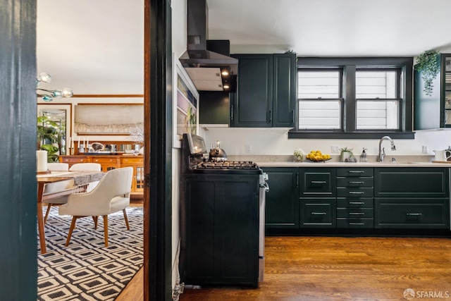 831 45th Ave, San Francisco, CA 94121 - kitchen featuring stainless steel gas stove, light countertops, custom exhaust hood, and wood finished floors