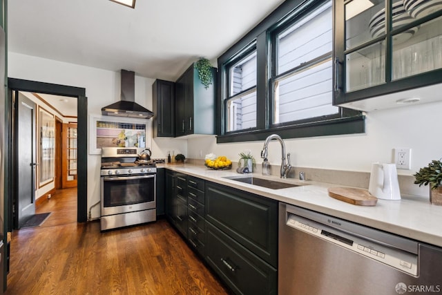 831 45th Ave, San Francisco, CA 94121 - kitchen with stainless steel appliances, wall chimney range hood, light countertops, and dark cabinets