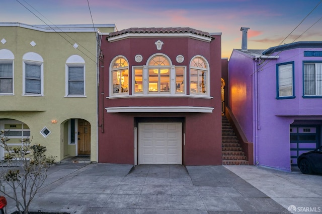 831 45th Ave, San Francisco, CA 94121 - view of front facade featuring stucco siding, a garage, and concrete driveway