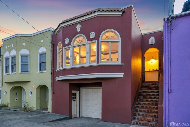 831 45th Ave, San Francisco, CA 94121 - mediterranean / spanish-style house featuring stucco siding, an attached garage, a tile roof, and concrete driveway