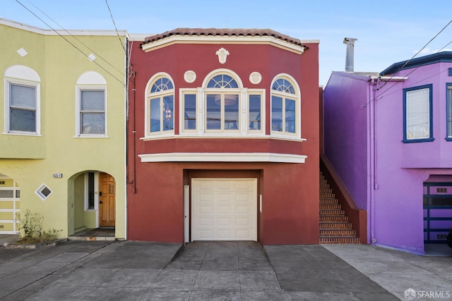 831 45th Ave, San Francisco, CA 94121 - view of property with stucco siding, driveway, and an attached garage
