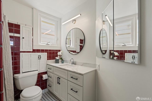 462 Clipper St, San Francisco, CA 94114 - full bathroom featuring vanity, toilet, tile walls, and tile patterned floors