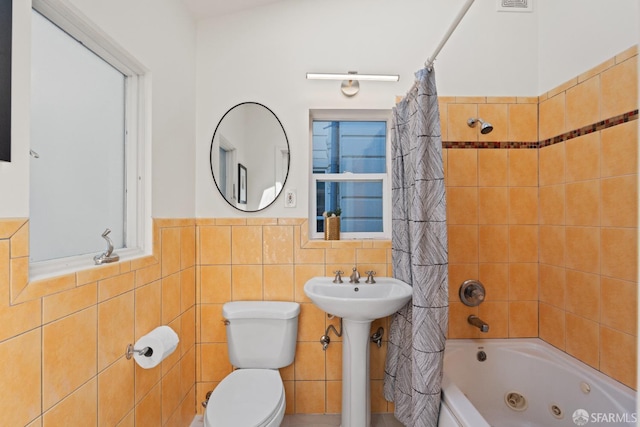 462 Clipper St, San Francisco, CA 94114 - full bath with tile walls, a combined bath / shower with jetted tub, toilet, a sink, and wainscoting