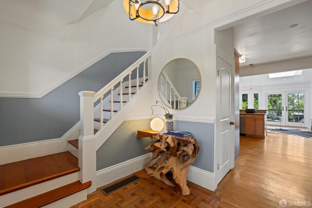 462 Clipper St, San Francisco, CA 94114 - stairs with a chandelier, baseboards, and a skylight
