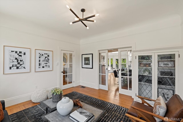 462 Clipper St, San Francisco, CA 94114 - living room featuring french doors, a chandelier, wood finished floors, and baseboards
