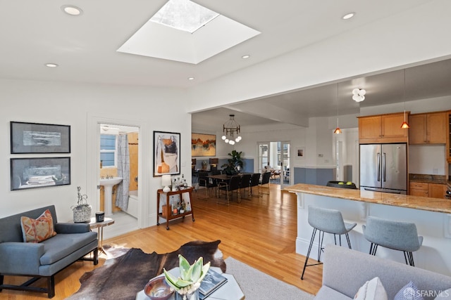 462 Clipper St, San Francisco, CA 94114 - living room featuring light wood-style floors, a skylight, a chandelier, recessed lighting, and vaulted ceiling