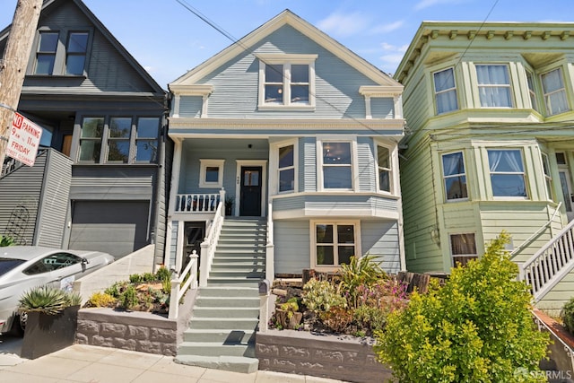 462 Clipper St, San Francisco, CA 94114 - view of front facade with stairs, a garage, and covered porch