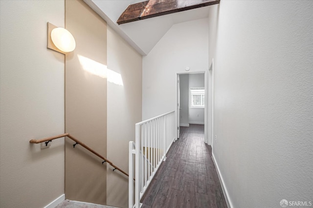 corridor featuring vaulted ceiling with beams and dark hardwood / wood-style flooring