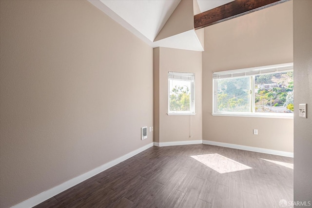 spare room with hardwood / wood-style flooring and high vaulted ceiling