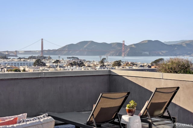 balcony featuring a water and mountain view