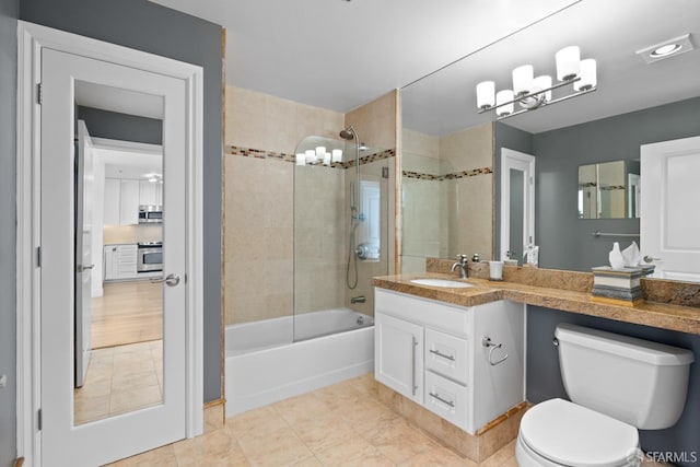 full bathroom with tile patterned floors, toilet, an inviting chandelier, bathtub / shower combination, and vanity