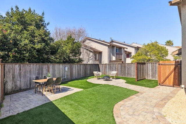 view of yard featuring a patio, a fire pit, and a fenced backyard