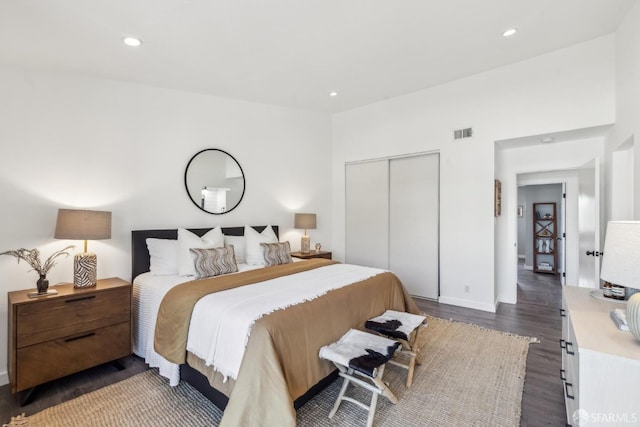 bedroom with recessed lighting, visible vents, a closet, and dark wood finished floors