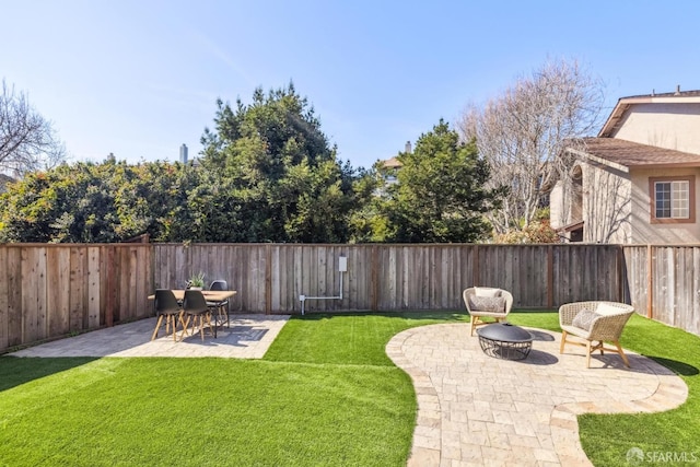 view of yard with an outdoor fire pit, a fenced backyard, and a patio area