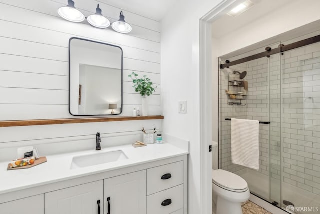 full bath with toilet, a stall shower, and vanity