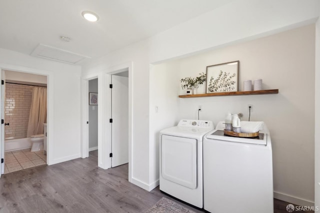 laundry area featuring dark wood finished floors, independent washer and dryer, attic access, and baseboards