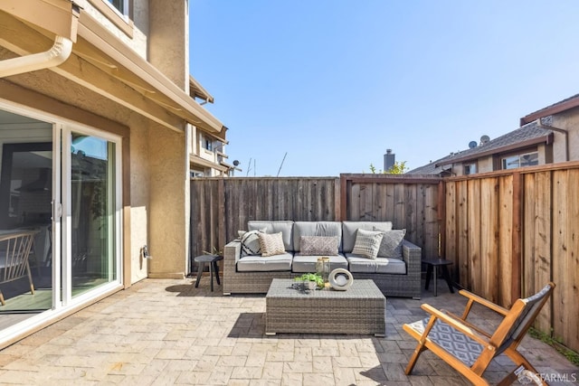 view of patio featuring an outdoor hangout area and a fenced backyard