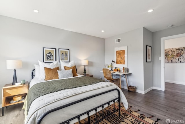 bedroom with visible vents, recessed lighting, baseboards, and wood finished floors