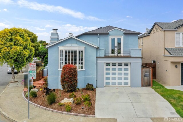 20 Rossmoor Dr, San Francisco, CA 94132 - view of front facade with a balcony, stucco siding, driveway, a garage, and french doors
