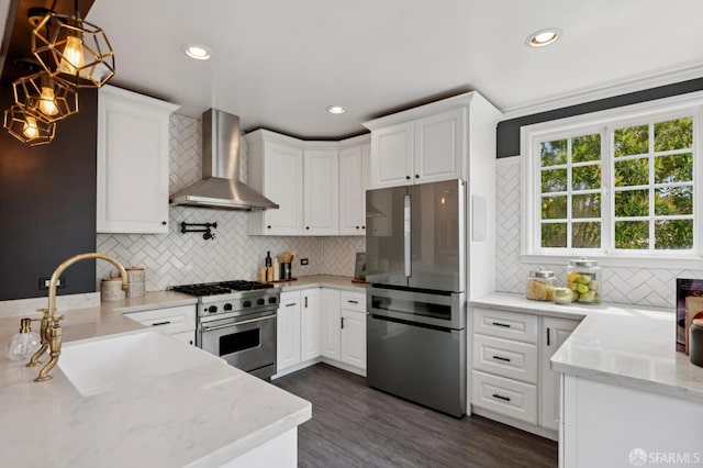 20 Rossmoor Dr, San Francisco, CA 94132 - kitchen featuring stainless steel appliances, wall chimney exhaust hood, white cabinets, decorative backsplash, and recessed lighting